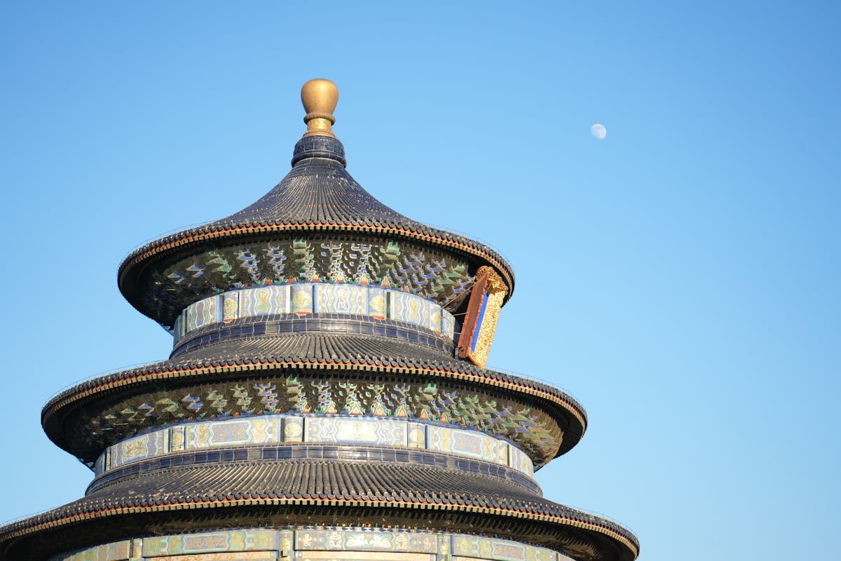 Temple of Heaven iconic circular building against blue sky in Beijing
