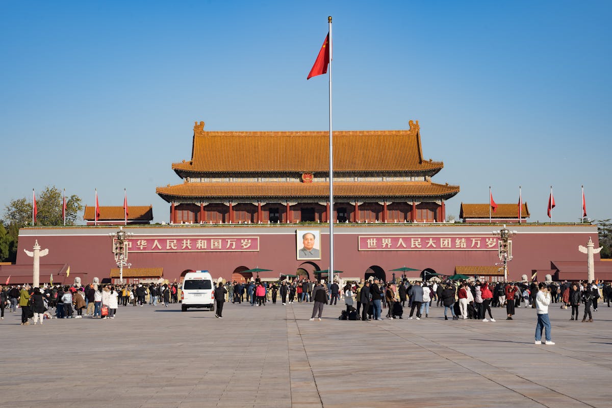 Tourists visiting Tiananmen Gate and the Forbidden City entrance in Beijing