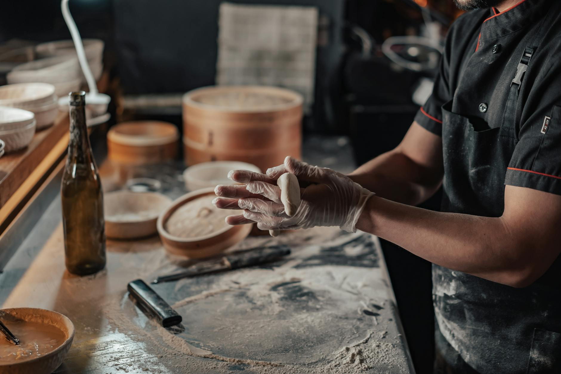 A chef crafting dumplings by hand in a kitchen