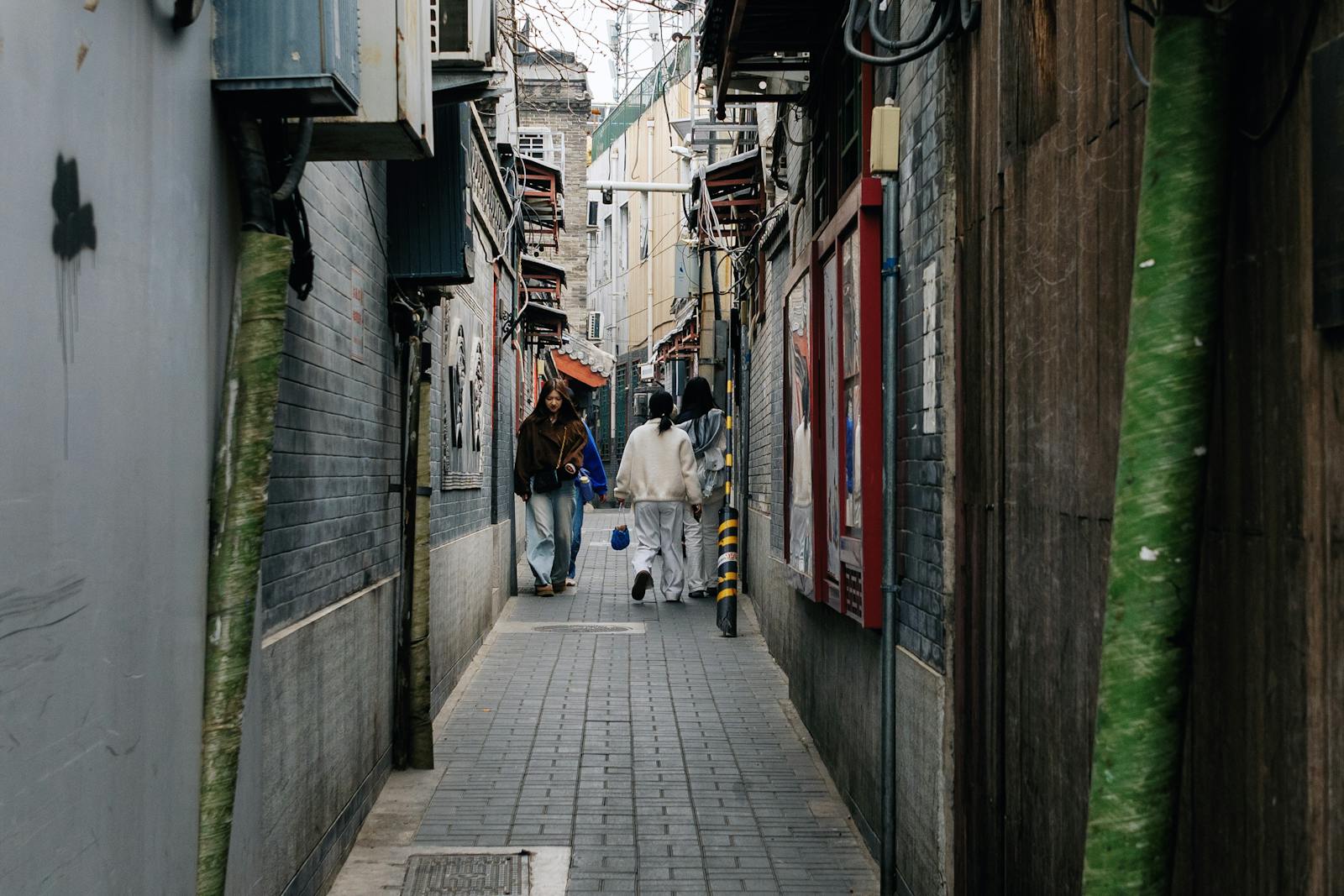 Beijing hutong narrow alley with people walking