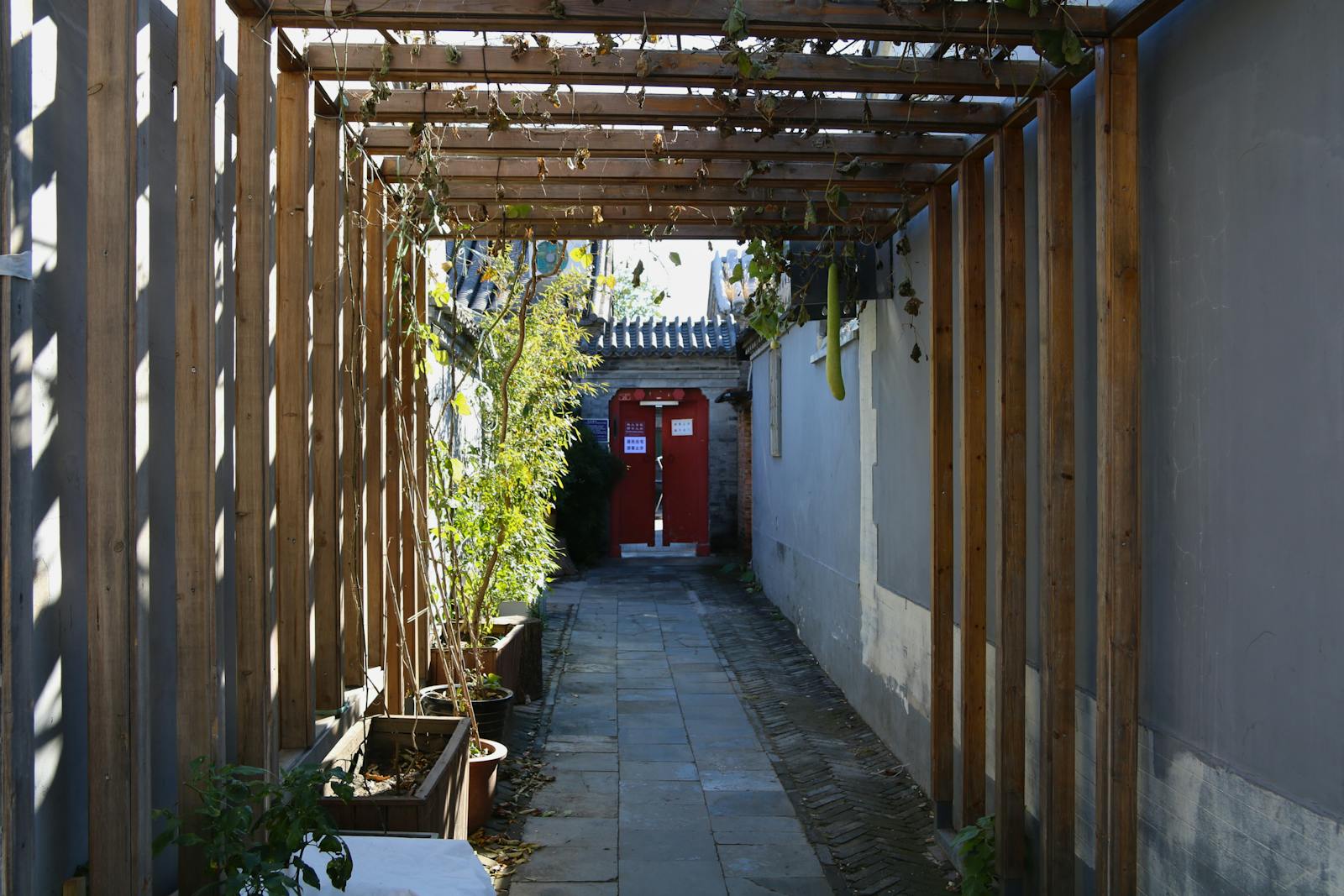 Beijing hutong narrow alley with red wooden doors