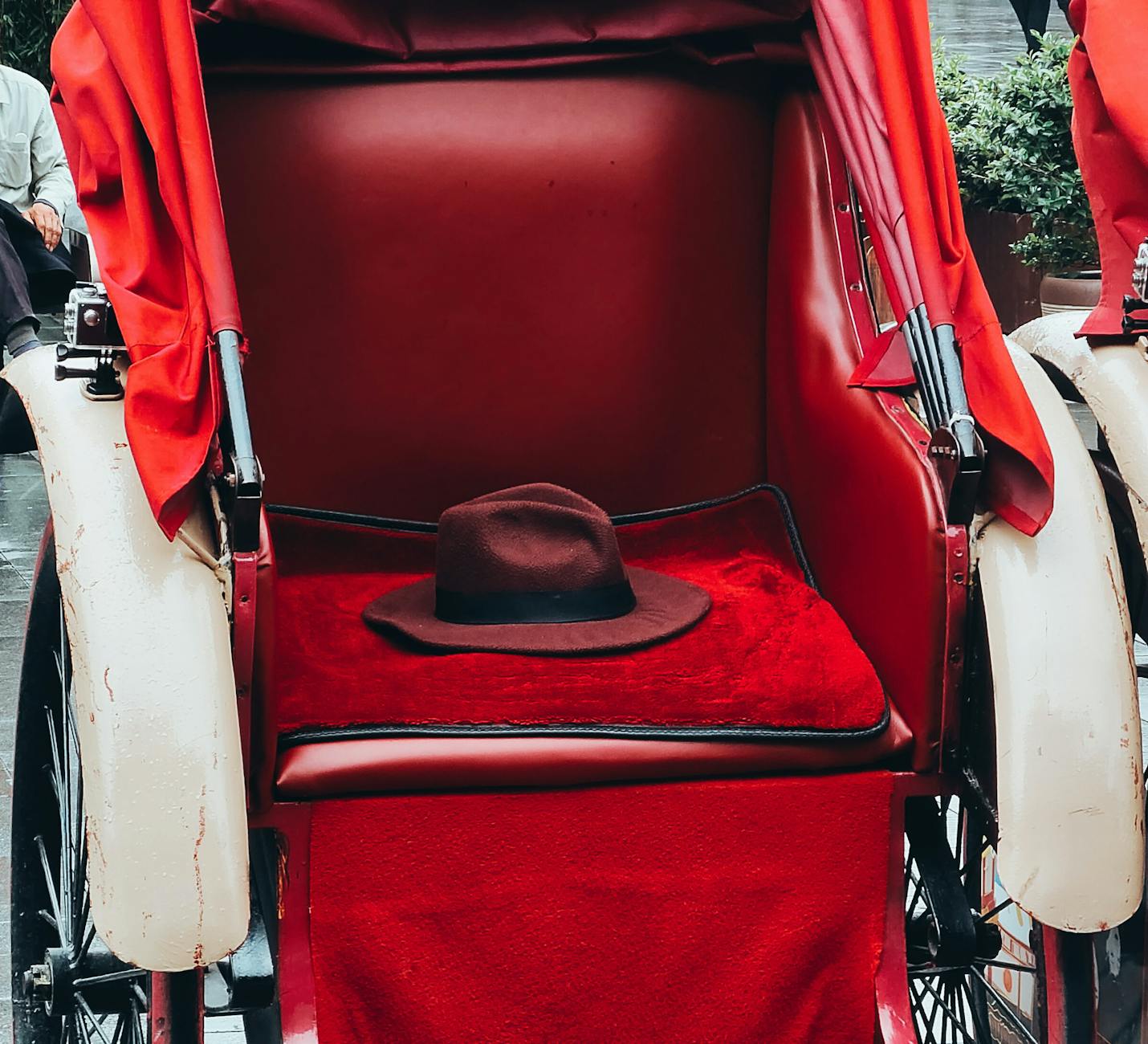 A classic red rickshaw waiting in old Beijing