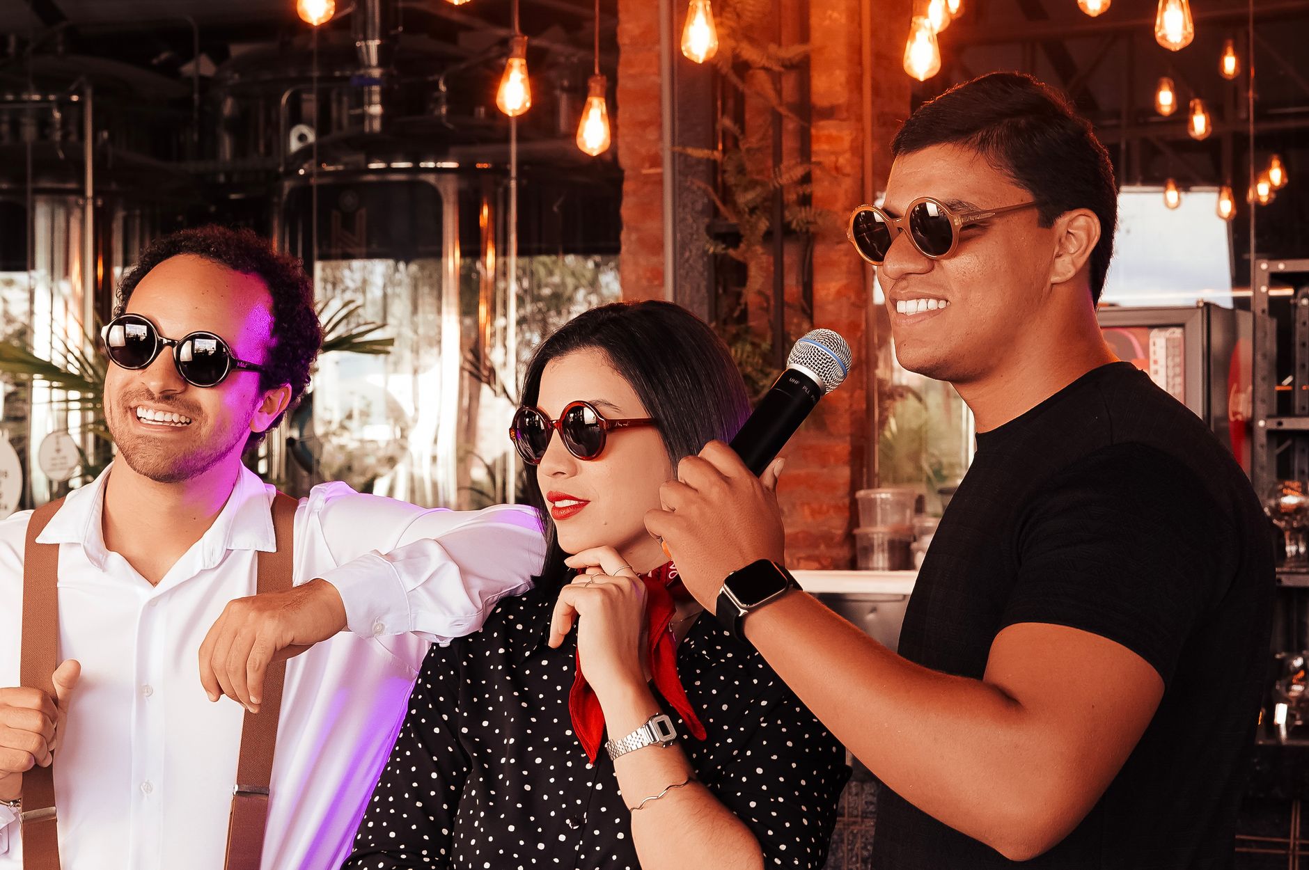 Three friends enjoying a karaoke session in a private room