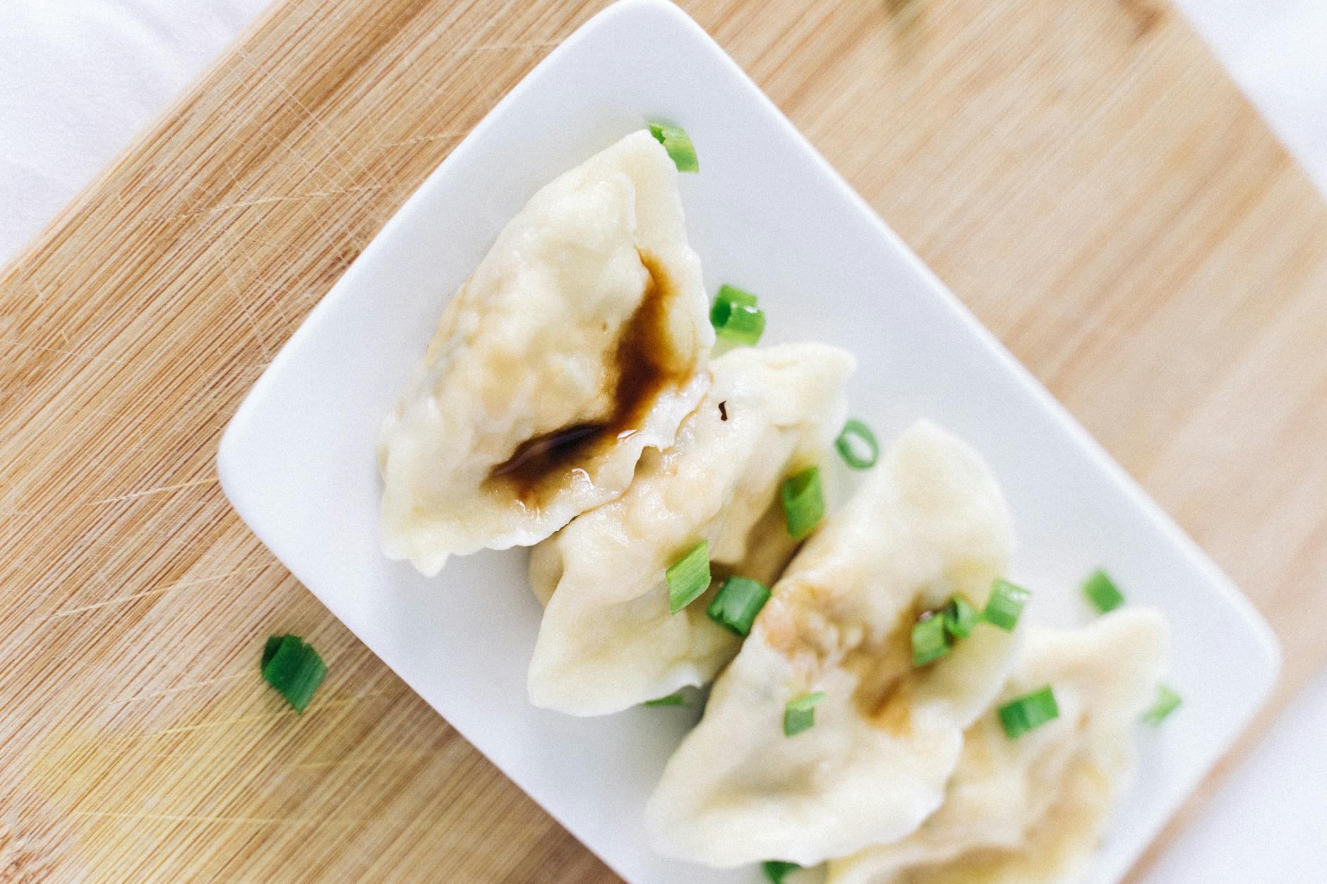 Chinese dumplings served with soy sauce and scallions