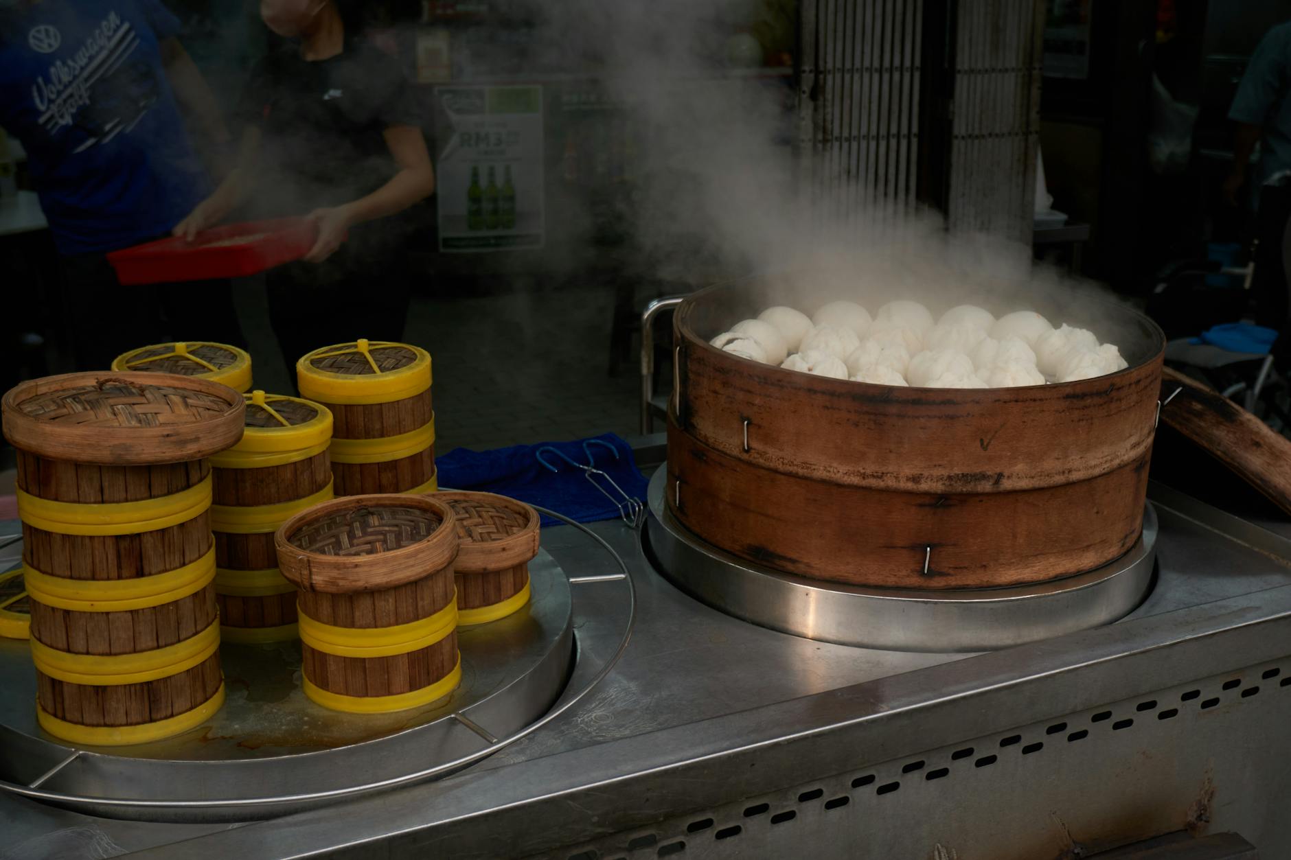 Freshly steamed Chinese bao buns in bamboo baskets