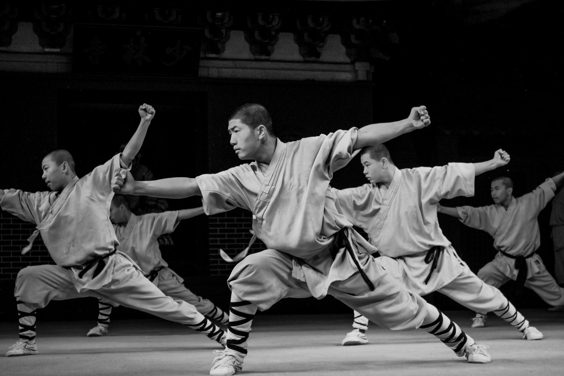 A group of martial artists performing a synchronised routine