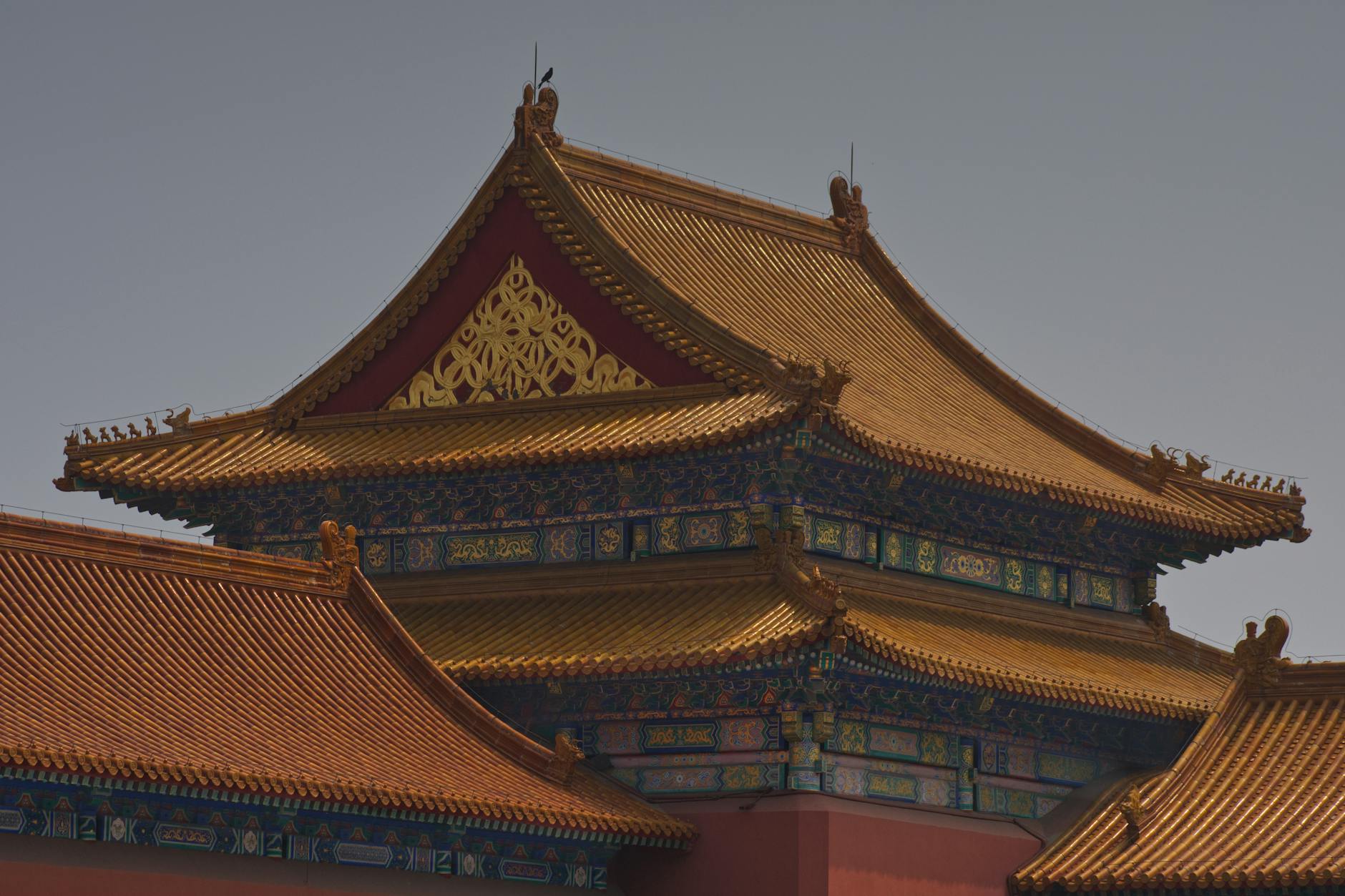 Intricate traditional Chinese rooftop with golden detailing in Beijing