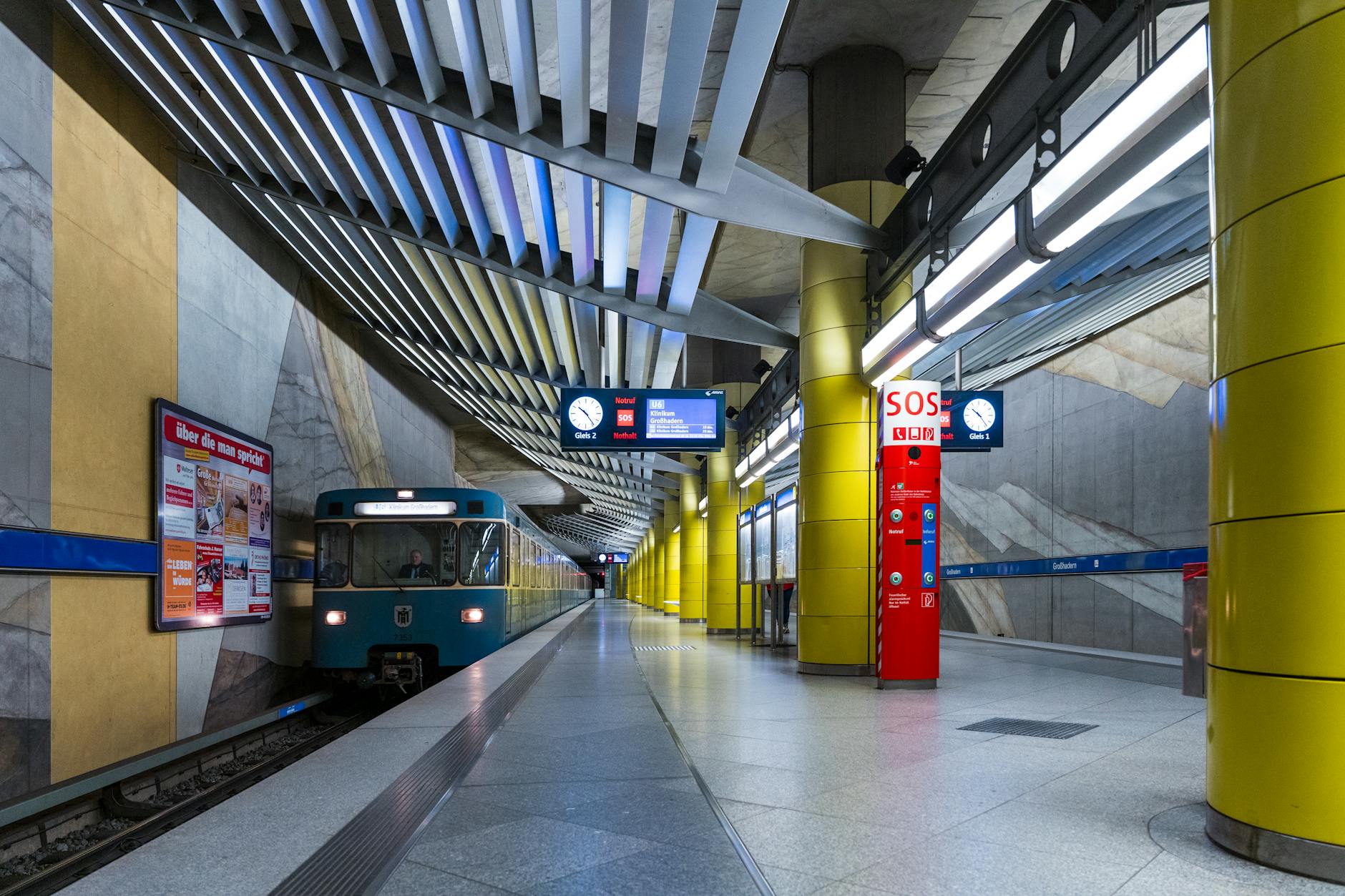 Modern Beijing subway train pulling into a station with English and Chinese signage