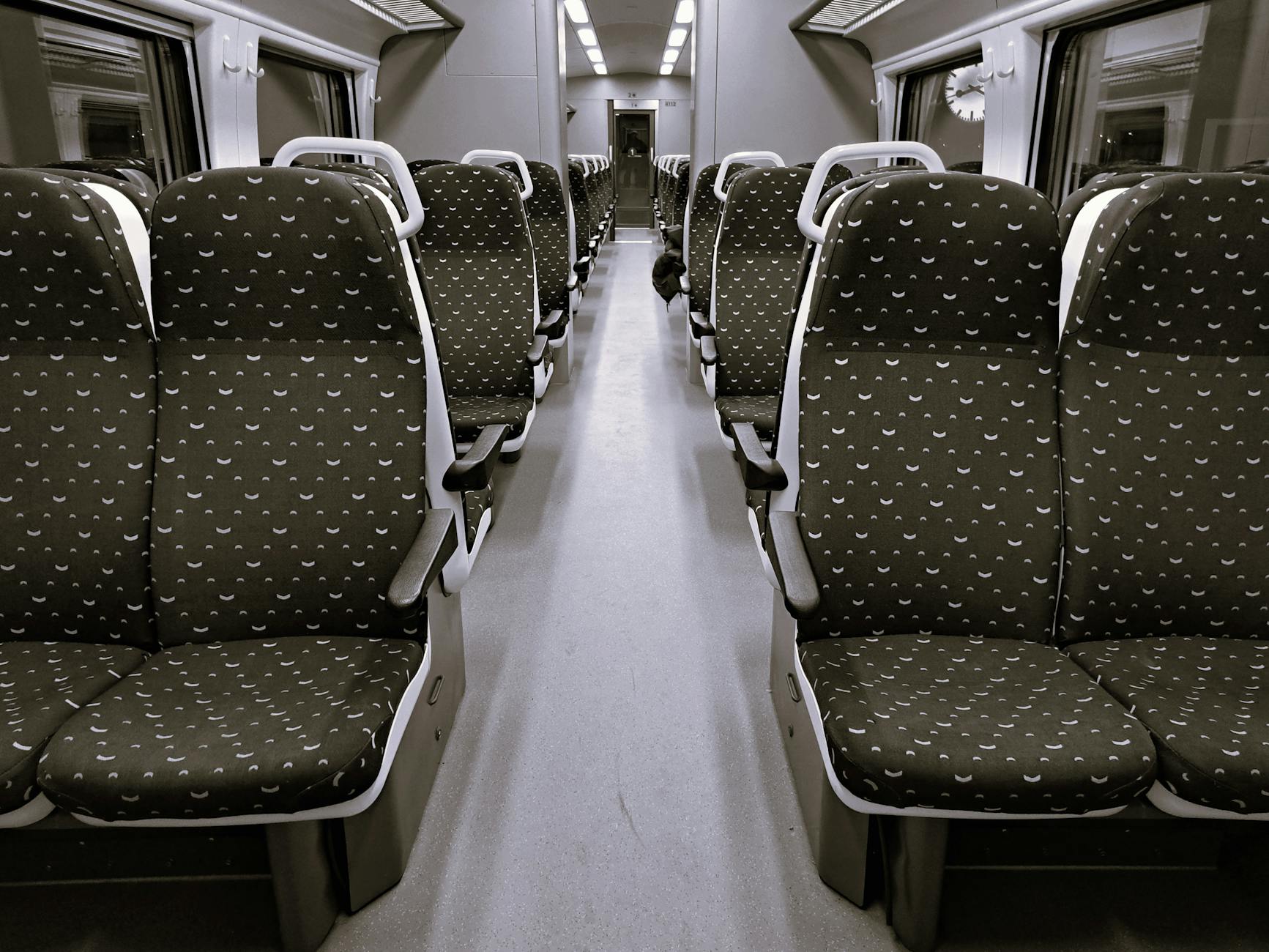 Interior of a modern Chinese high-speed train second class carriage with travelers seated