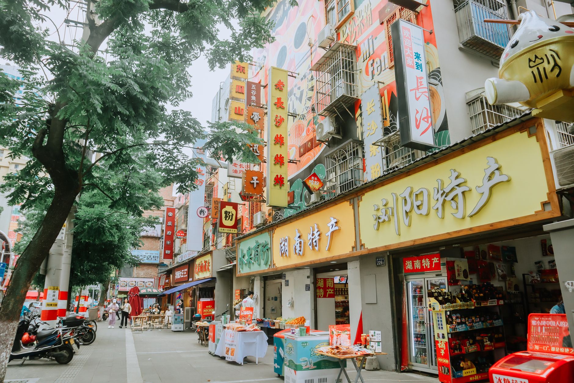 Colourful urban street with vibrant signs and shops
