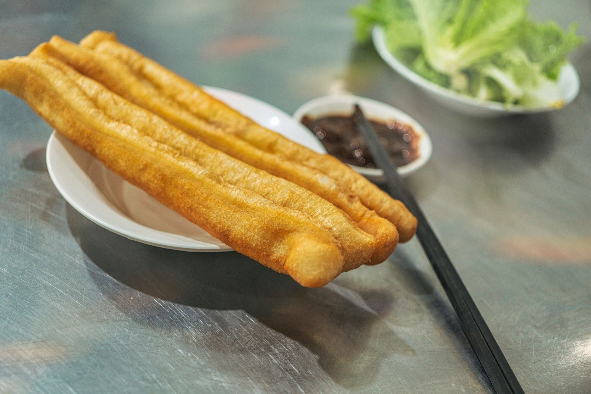 Crispy youtiao fried dough sticks with dipping sauce