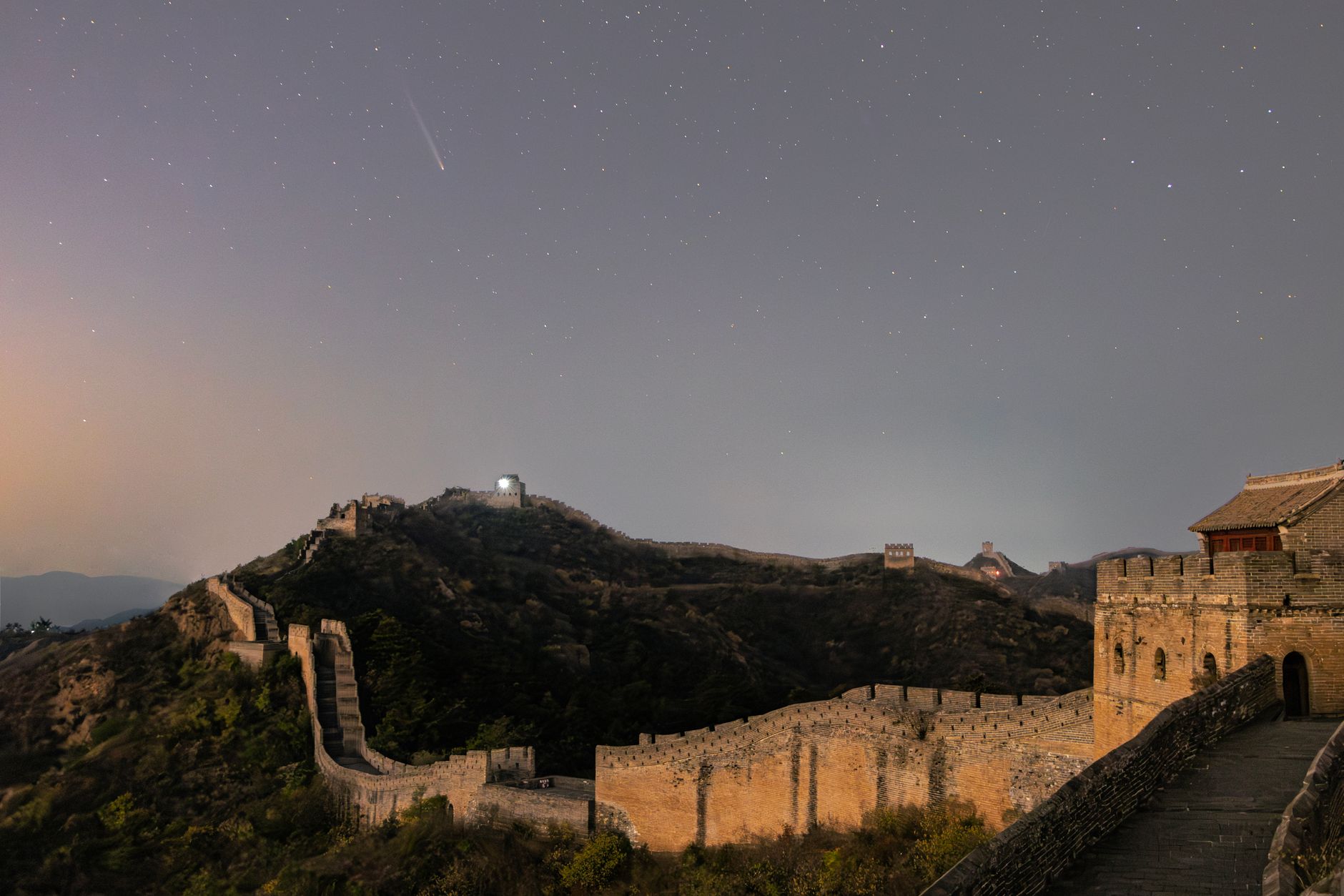 Simatai Great Wall illuminated at night with Gubei Water Town below