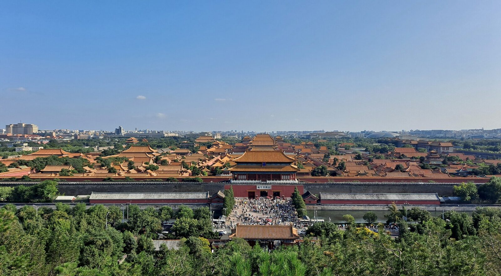 The Forbidden City seen from Jingshan Park, its gold roofs receding in ranks towards the Beijing skyline
