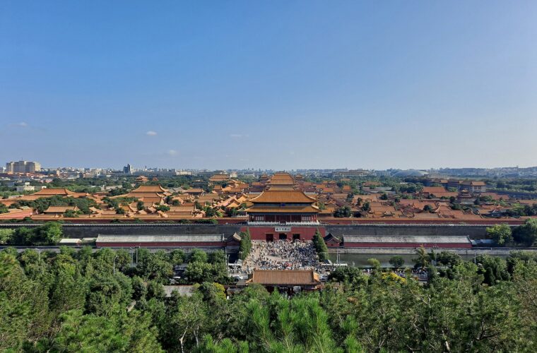 The Forbidden City seen from Jingshan Park, its gold roofs receding in ranks towards the Beijing skyline