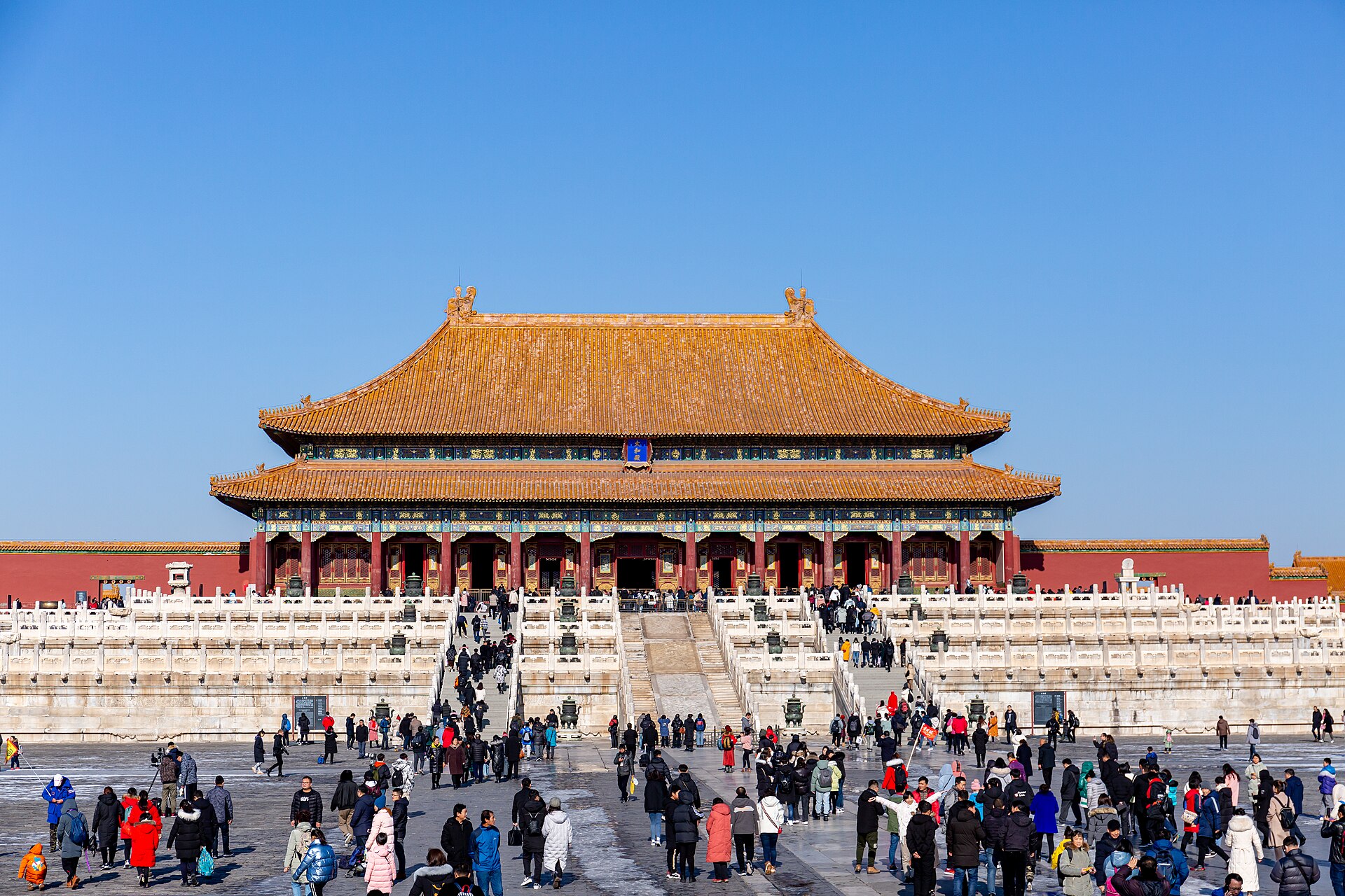 The Hall of Supreme Harmony in the Forbidden City above its white marble terraces with visitors crossing the courtyard below