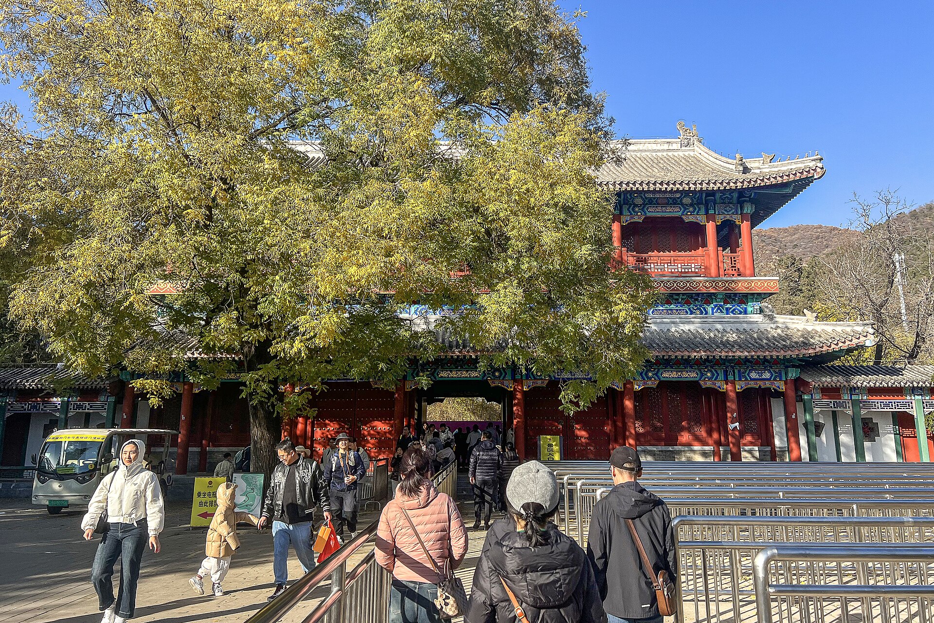 The painted entrance gatetower of Tanzhe Temple in Beijing's western hills under autumn trees