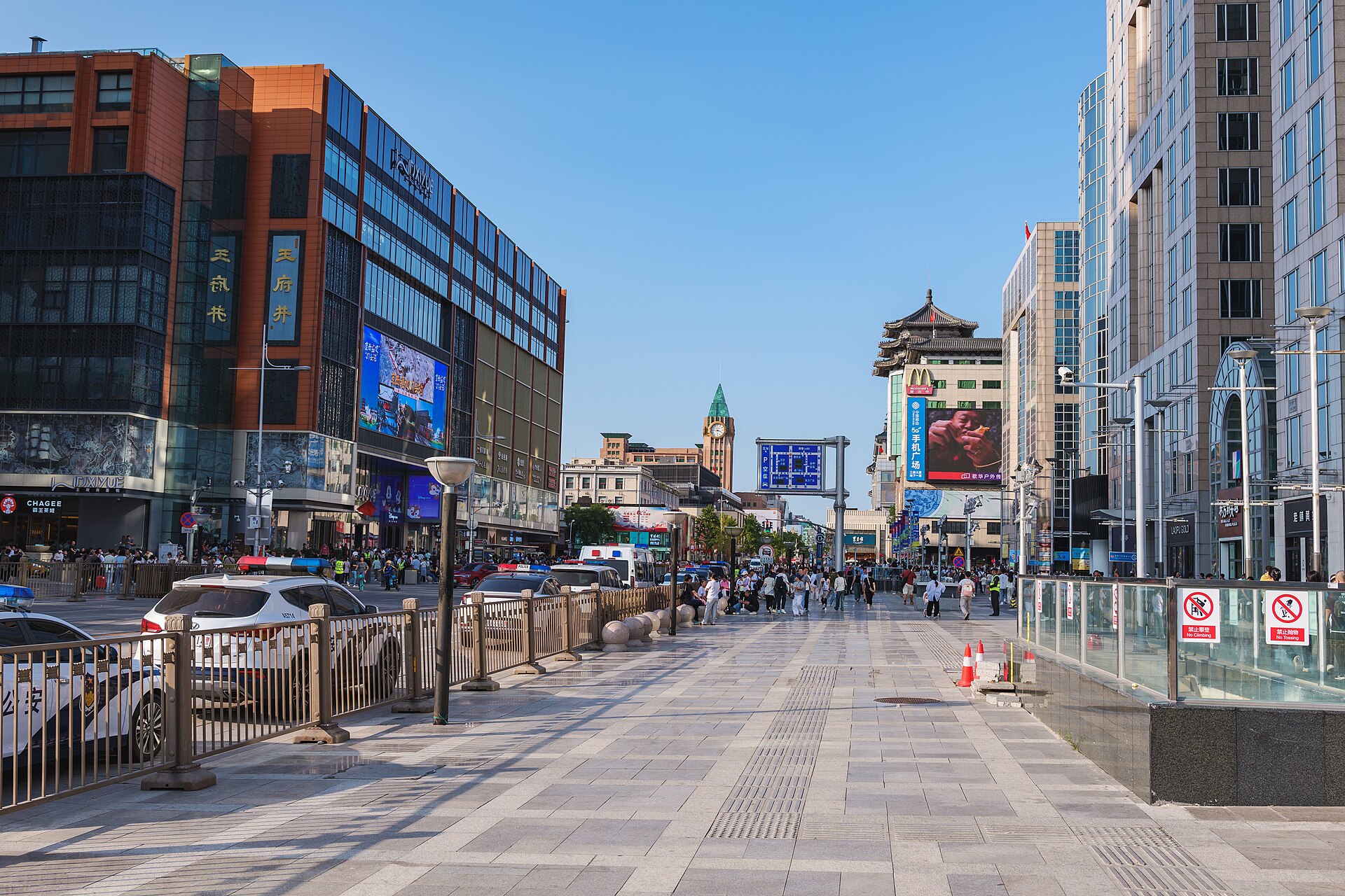 The pedestrianised Wangfujing shopping street in Beijing with department stores and the old clock tower behind