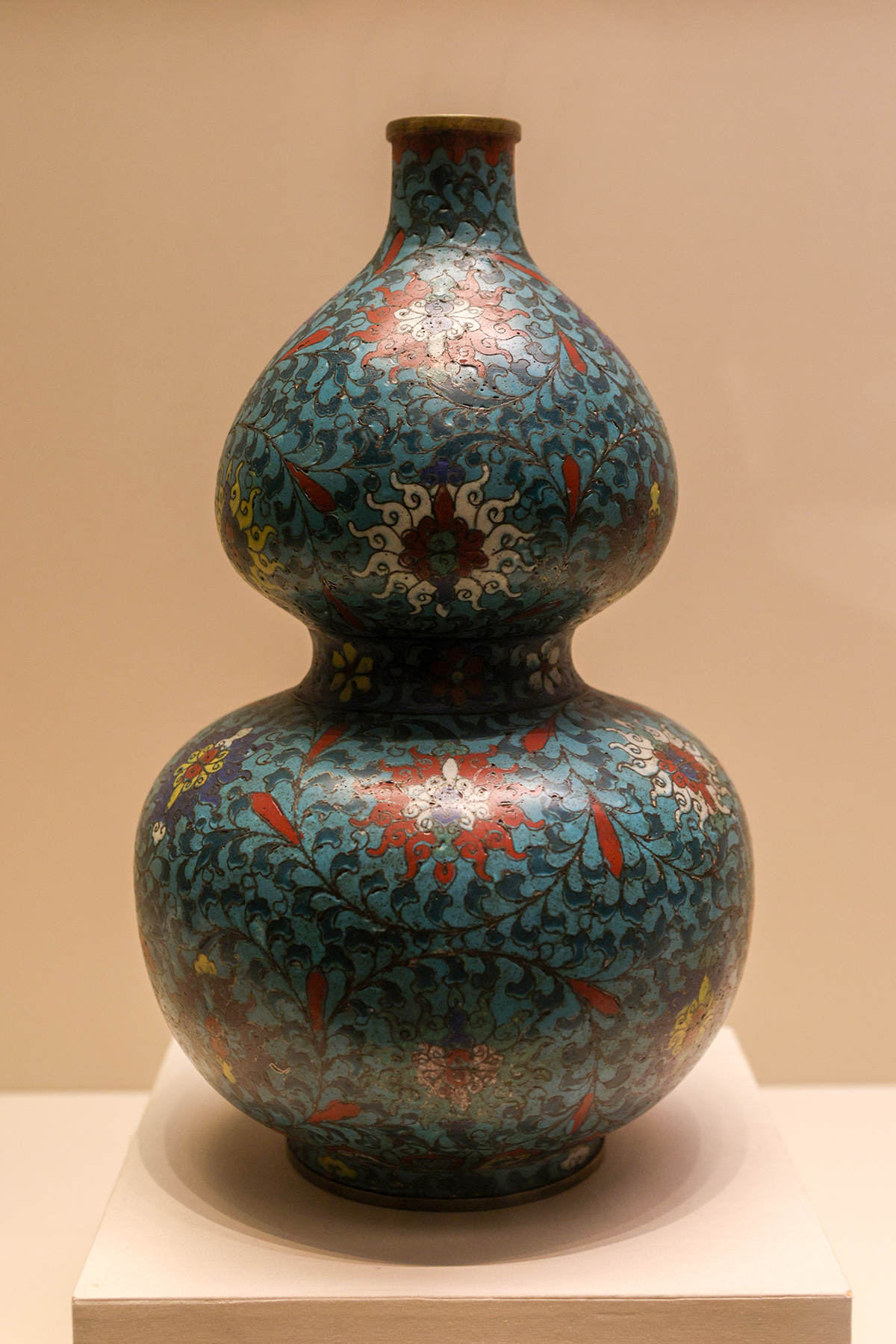 A double-gourd cloisonné bottle displays turquoise enamel and intricate floral wirework at the National Museum of China in Beijing.