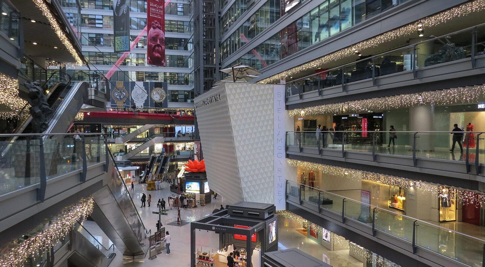 Escalators and glass walkways connect several floors of shops around the tall atrium at Parkview Green in Beijing.