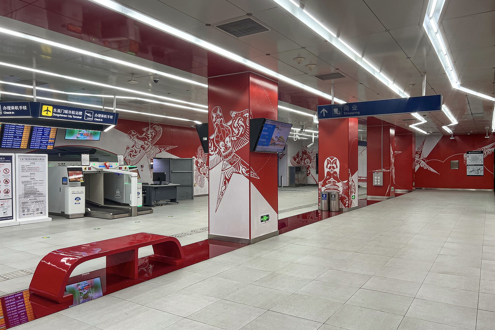 Red and white decorations surround airline check-in facilities in the Capital Airport Express concourse at Dongzhimen station in Beijing.